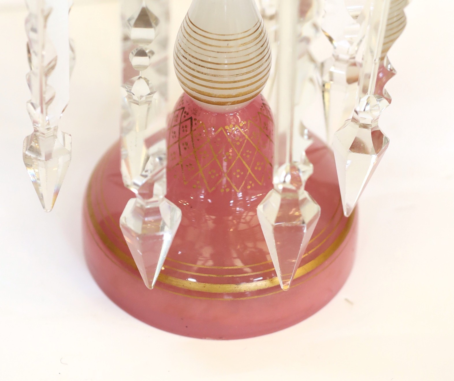 A pair of Victorian opaque pink and white glass lustre candelabra, with spear shaped finials and cut glass scrolling branches, height 52cm